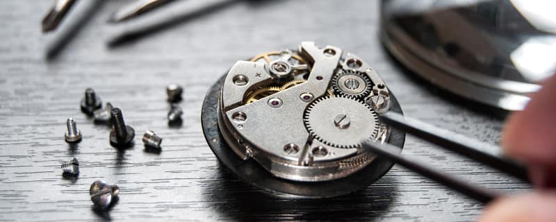 Back of a watch opened to expose the gears